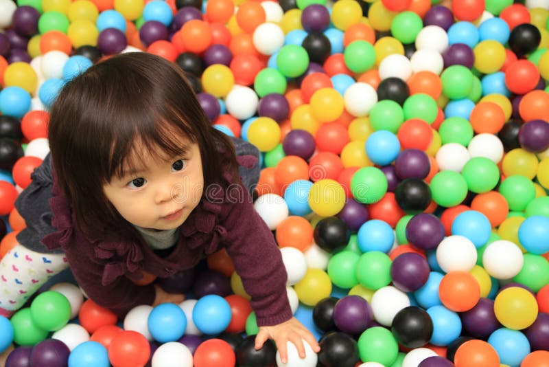 Japanese baby girl playing in ball pool