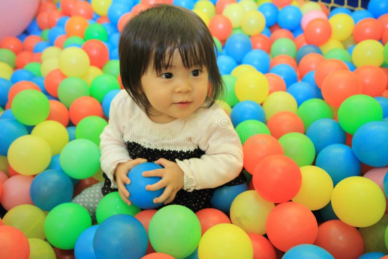 Japanese baby girl playing in ball pool