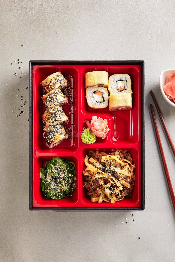 Japanese Bento Box with Sushi Rolls, Salad and Main Course Top V