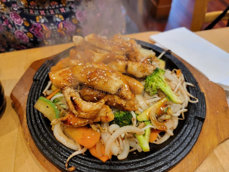 Japanese Chicken Stir Fry on Hot Plate with Vegatables Stock Photo