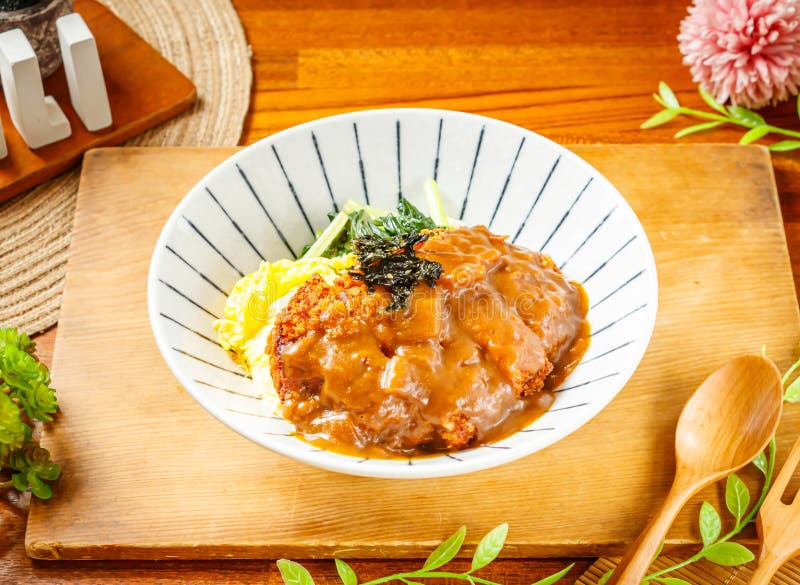 Japanese Curry Pork Chop Rice Served in Dish Isolated on Wooden Table