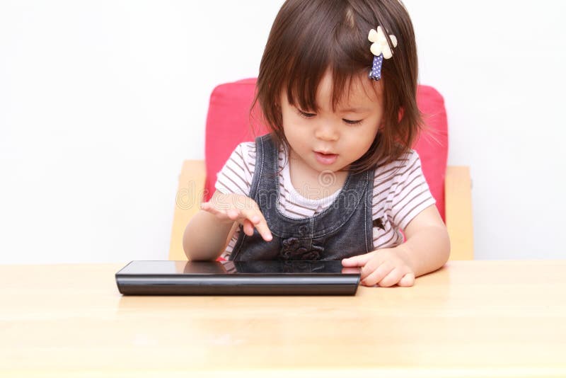 Japanese Girl Using a Tablet PC Stock Photo Image of smile, operate