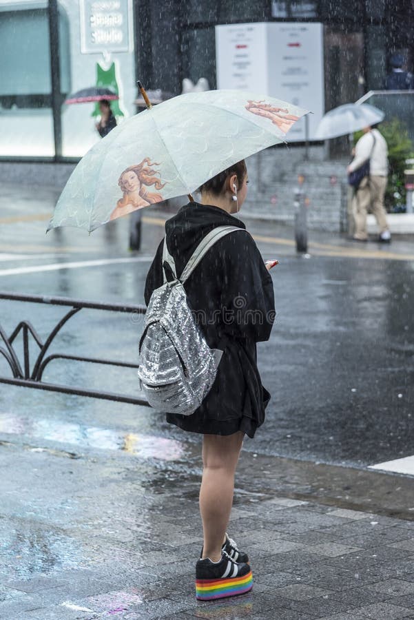 Japanese girl waiting heavy rain Tokyo royalty free stock images