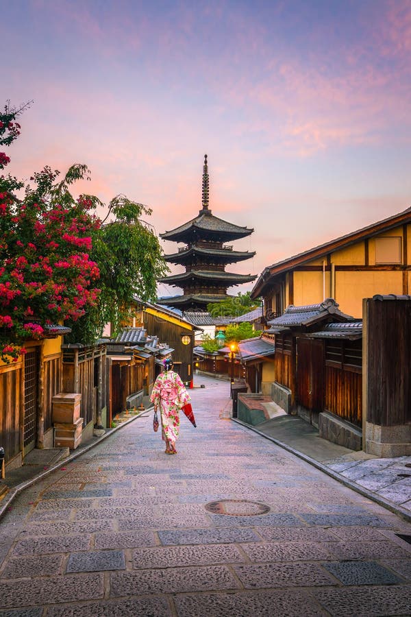 Japanese girl in Yukata with red umbrella in old town Kyoto royalty free stock photography