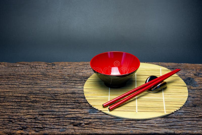 Japanese Kitchenware Set of Red Chopsticks, Bowls and Cup on Bamboo Mat on  Wooden Table Stock Image - Image of bowls, oriental: 114304811