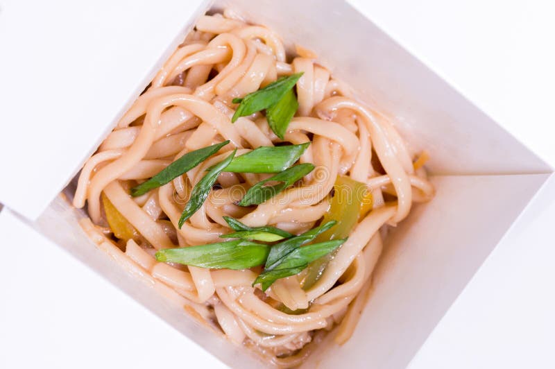 Japanese Noodles in a Box. Noodles with Sauce and Greens Stock Photo