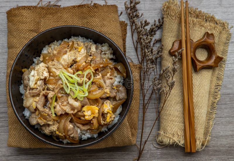 Japanese Pork Rice Bowl with Egg and Onion Donburi Served with Pickled