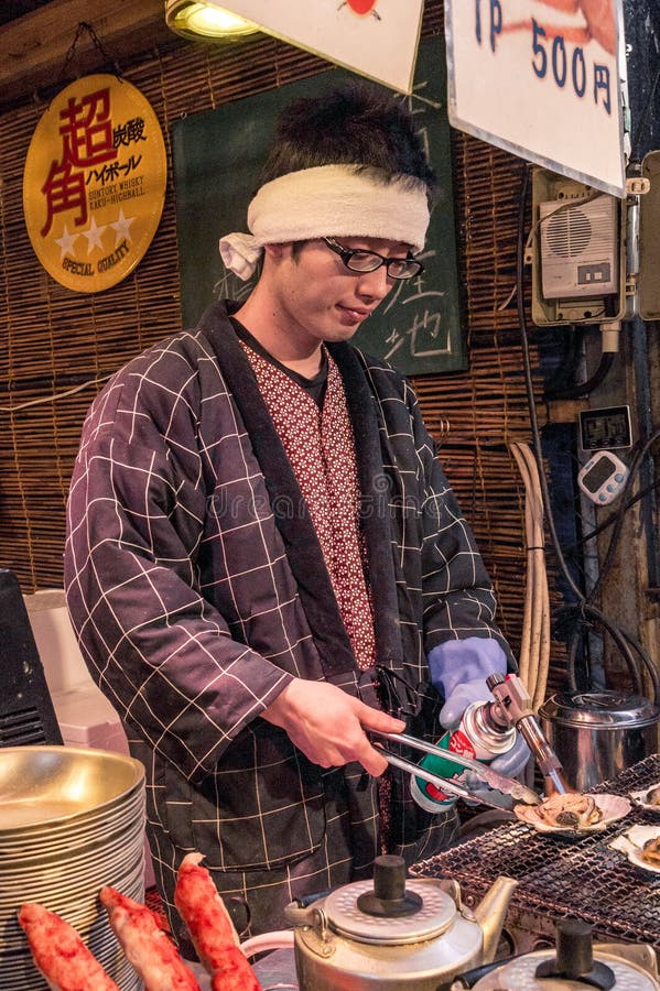 Japanese Street Food Vendor Grilling Oyster at Tsukiji Market in Tokyo