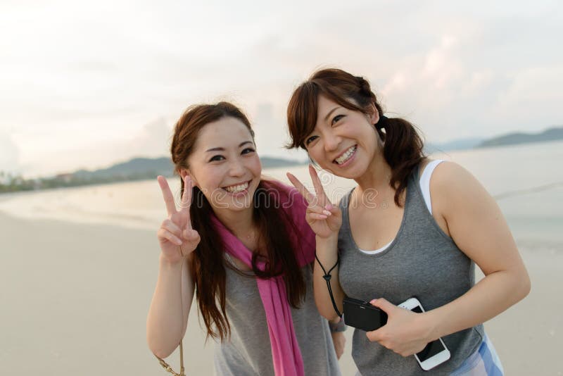 Japanese women posing on the beach