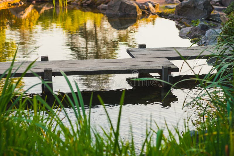 Japanese wooden bridge over pond