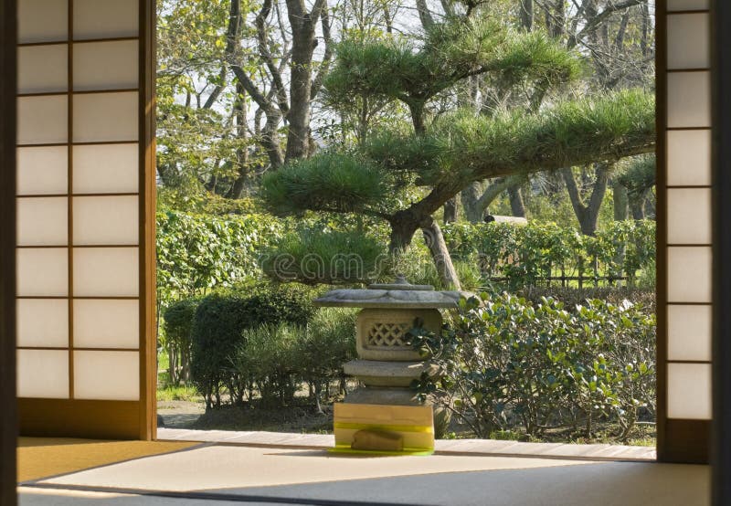 Japanese garden seen through a traditional sliding wall of a wooden house. Japanese garden seen through a traditional sliding wall of a wooden house.