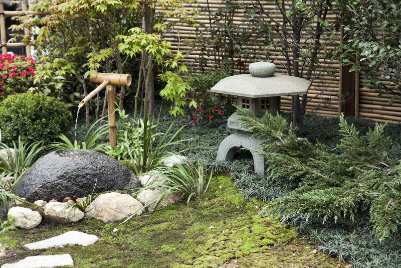 Stone Lantern and Bamboo Water Fountain in a Japanese Garden. Stone Lantern and Bamboo Water Fountain in a Japanese Garden