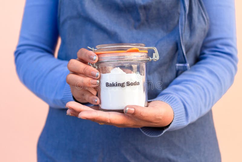 Jar of Baking Soda in Woman Hand.cleaning Concept. Stock Photo Image