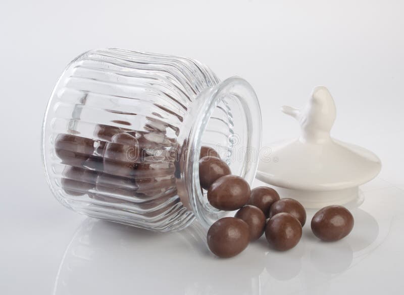 Jar or Glass Jar with Chocolate Ball on the Background. Stock Image