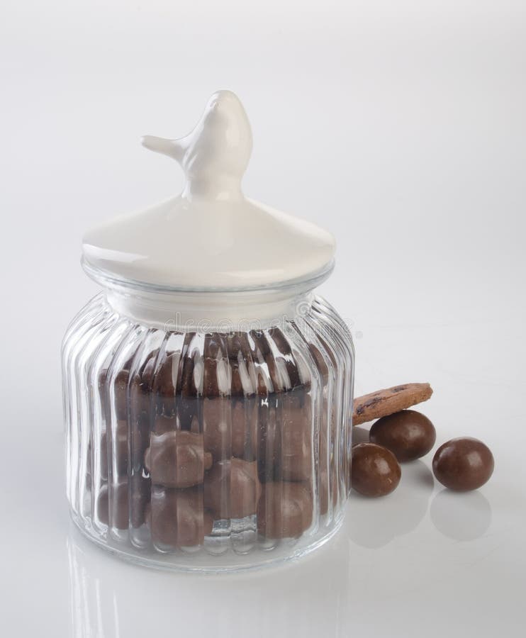 Jar or Glass Jar with Chocolate Ball on the Background. Stock Photo