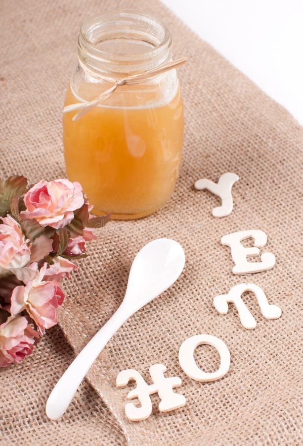 Jar with honey and spoon stock photo. Image of organic 32319138