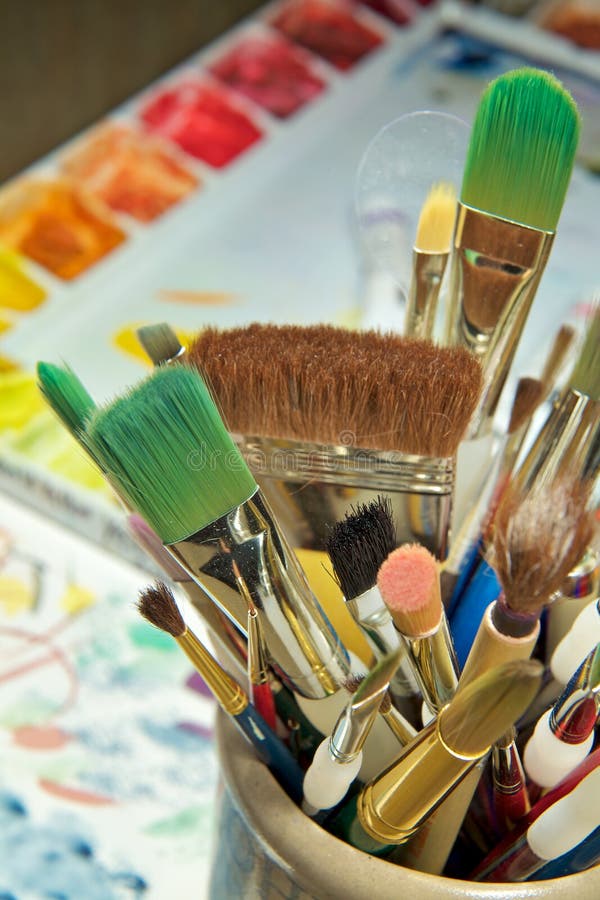 Artist paintbrushes, paint tubes and small easel with canvas closeup. Top  view. Stock Photo by ©ChamilleWhite 184639884