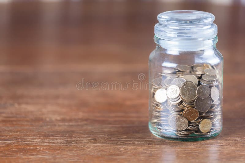 Jar savings spare change concept dark background. royalty free stock photography