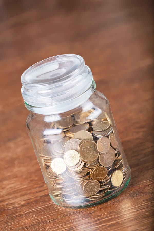 Jar savings spare change concept dark background. royalty free stock photos