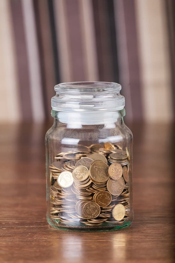 Jar savings spare change concept dark background. royalty free stock photos