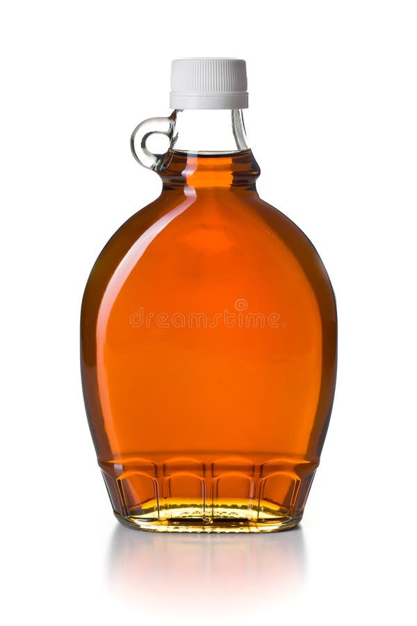 Jarabe de arce en la botella de cristal imágenes de archivo libres de regalías
