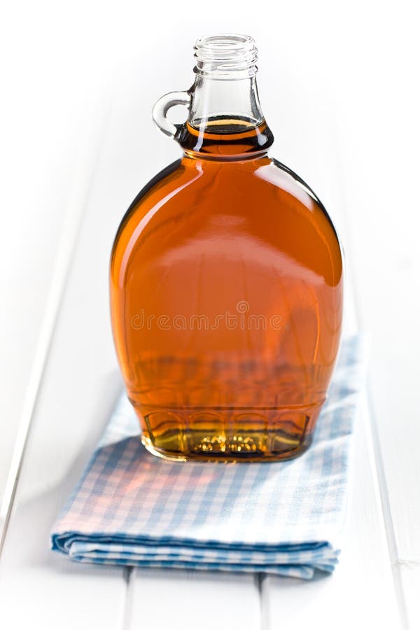 Jarabe de arce en la botella de cristal imagen de archivo