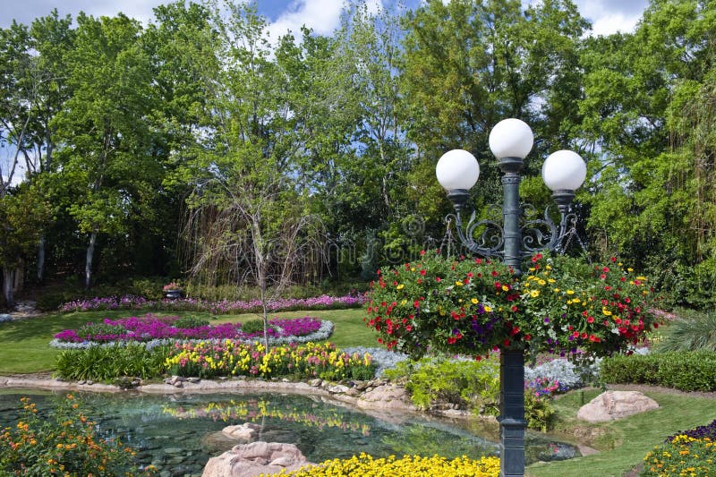 A view of a beautiful flower garden with a reflecting pool. A view of a beautiful flower garden with a reflecting pool.