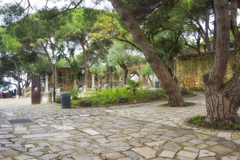 Saint George Castle is a Moorish castle occupying a commanding hilltop overlooking the historic centre of the Portuguese city of Lisbon and Tagus River. The strongly fortified citadel dates from medieval period of Portuguese history, and is one of the main tourist sites of Lisbon. Although the first fortifications on this hilltop date from the 2nd century BC, archaeological excavations have identified a human presence in the Tagus valley as far back as the 6th century BC. The first fortification was, presumably, erected in 48 BC, when Lisbon was classified as a Roman municipality. The hill was first used by indigenous Celtic tribes, then by Phoenicians, Greeks, and Carthaginians as a defensible outpost that was later expropriated by Roman, Suebic, Visigothic, and Moorish peoples. During the 10th century, the fortifications were rebuilt by Muslim Berber forces, these included the walls or Cerca Moura `Moorish Encirclement`. Saint George Castle is a Moorish castle occupying a commanding hilltop overlooking the historic centre of the Portuguese city of Lisbon and Tagus River. The strongly fortified citadel dates from medieval period of Portuguese history, and is one of the main tourist sites of Lisbon. Although the first fortifications on this hilltop date from the 2nd century BC, archaeological excavations have identified a human presence in the Tagus valley as far back as the 6th century BC. The first fortification was, presumably, erected in 48 BC, when Lisbon was classified as a Roman municipality. The hill was first used by indigenous Celtic tribes, then by Phoenicians, Greeks, and Carthaginians as a defensible outpost that was later expropriated by Roman, Suebic, Visigothic, and Moorish peoples. During the 10th century, the fortifications were rebuilt by Muslim Berber forces, these included the walls or Cerca Moura `Moorish Encirclement`.