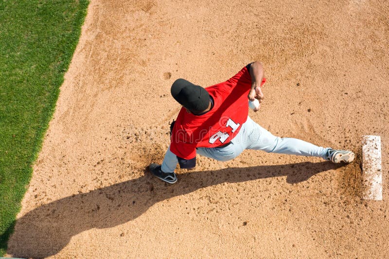 A baseball pitcher throwing a pitch with copy space. A baseball pitcher throwing a pitch with copy space