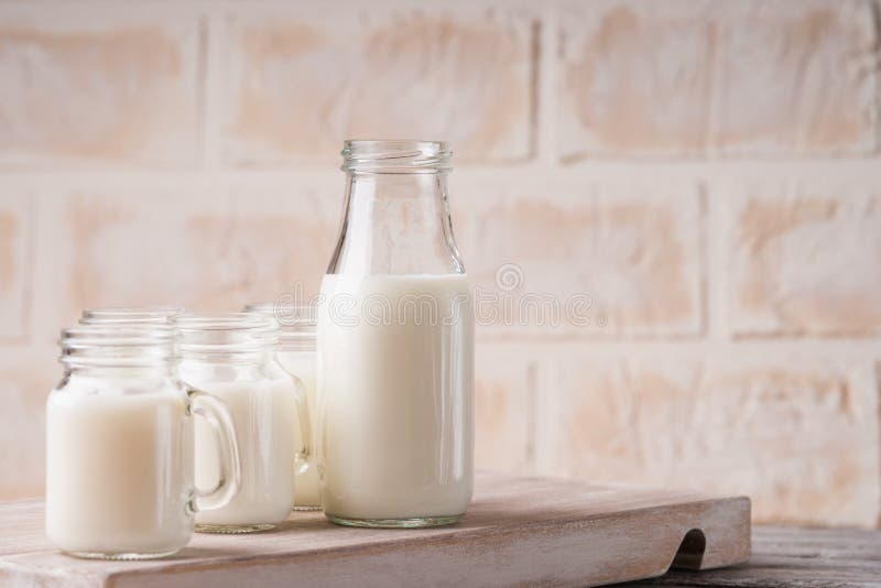 Milk Jars With Colorful Caps On A Cutting Board And ...