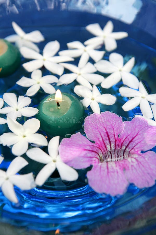 Jasmine, and pink Asarina, candles and blue water. Floral Mediterranean aromatheraphy