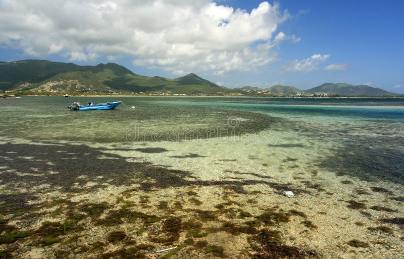 A small boat floats in the waters off Coconut Grove, St. Maarten. A small boat floats in the waters off Coconut Grove, St. Maarten.