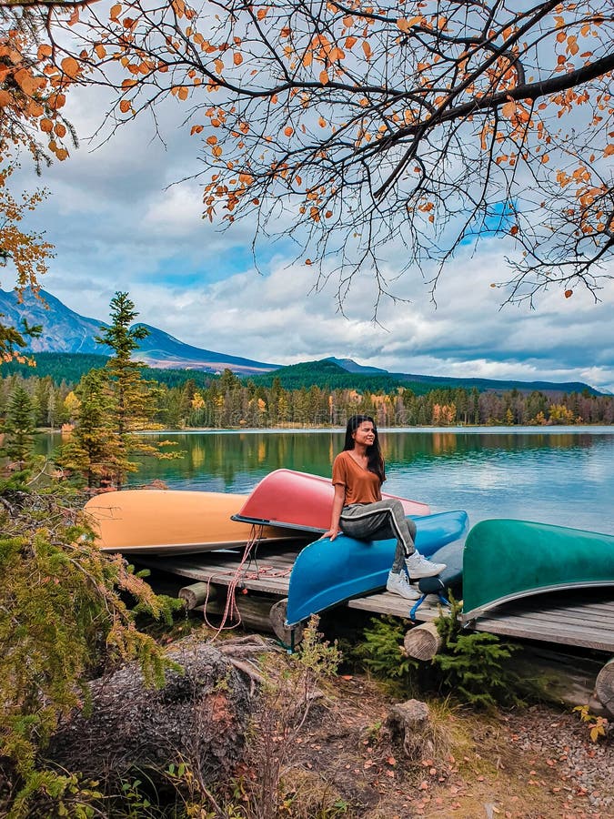 Jasper town Canada, girl at lakeshore, sunrise by the lake at Jasper , Lac Beauvert Alberta Canadian Rockies Canada