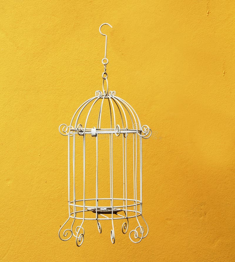 Classic bird cage on yellow wall. Classic bird cage on yellow wall