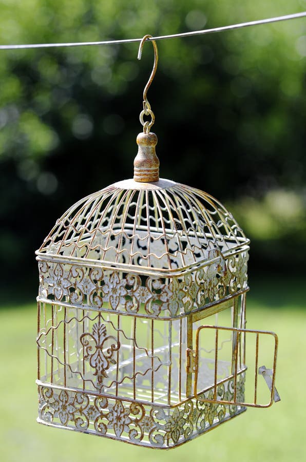 An opened bird cage outdoor. An opened bird cage outdoor