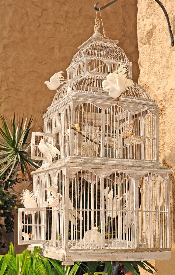 Large wooden bird cage with white doves. Large wooden bird cage with white doves.