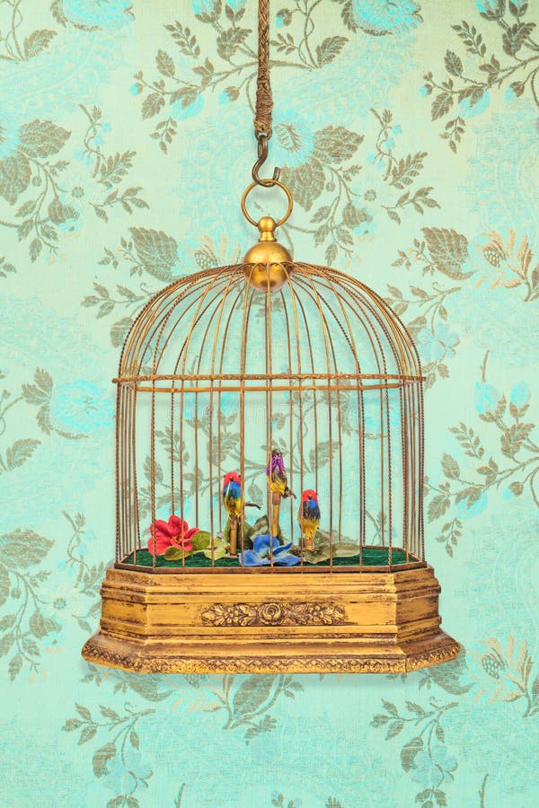 Vintage hanging birdcage with old figurine birds in front of wallpaper with flower pattern. Vintage hanging birdcage with old figurine birds in front of wallpaper with flower pattern