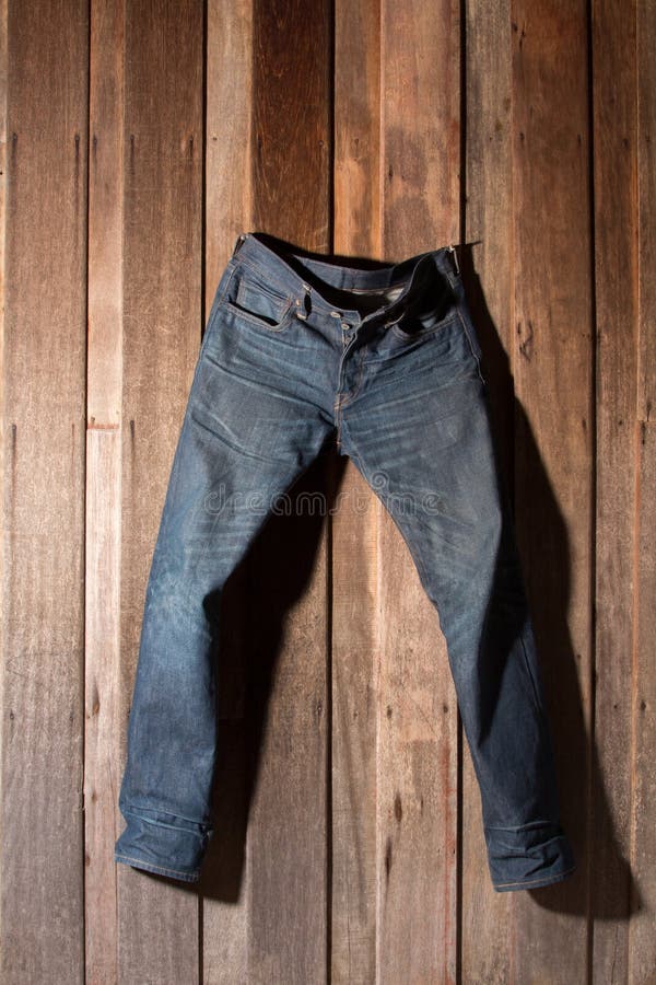 Jeans hanging wooden wall stock image. Image of closet - 37795087