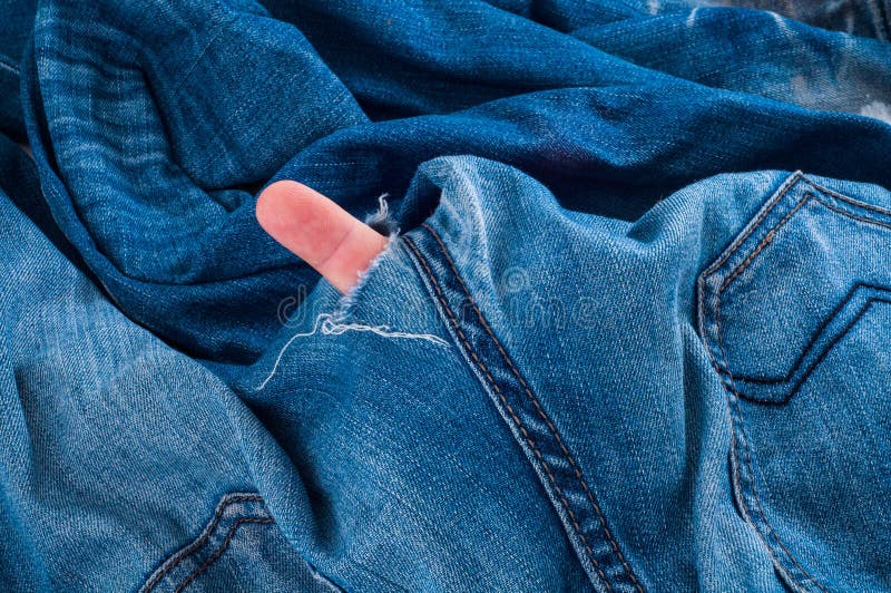 Jeans pants with finger in hole. 