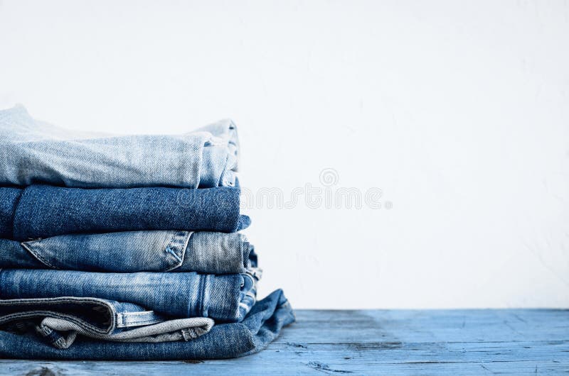 Jeans Stacked on a Wooden Table Stock Image - Image of material ...