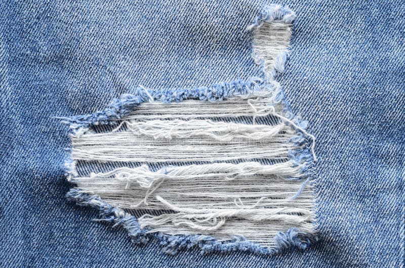 Jeans in wash blue with rip. Denim background, texture. Ripped d royalty free stock photo
