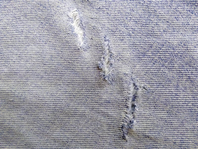 Jeans zerrissene Denim-Textur. zerstörter Jeanenhintergrund stockbild