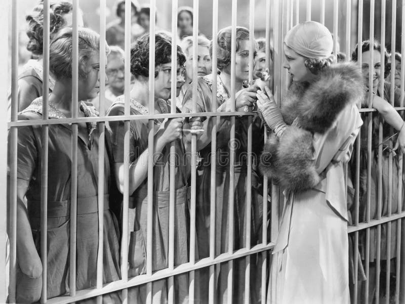 One woman standing in front of a jail talking with a group of women (All persons depicted are no longer living and no estate exists. Supplier grants that there will be no model release issues.). One woman standing in front of a jail talking with a group of women (All persons depicted are no longer living and no estate exists. Supplier grants that there will be no model release issues.)