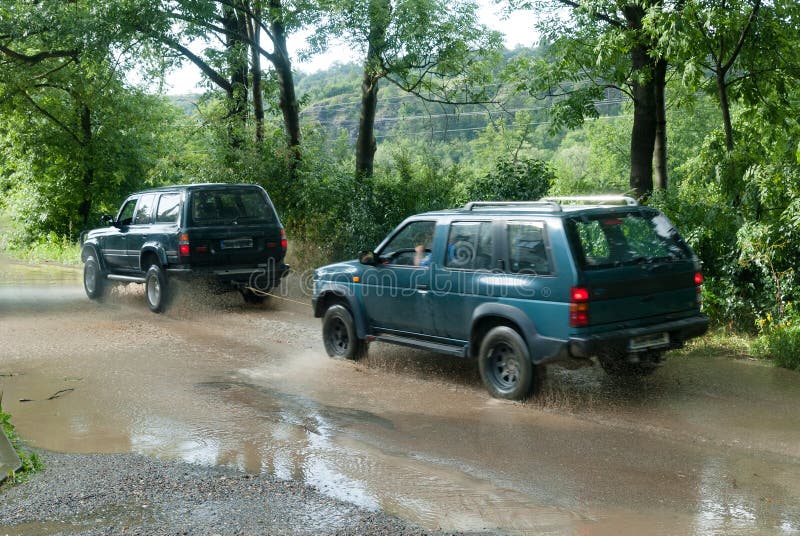 A Jeep Being Towed By Another Car Stock Photo Image of