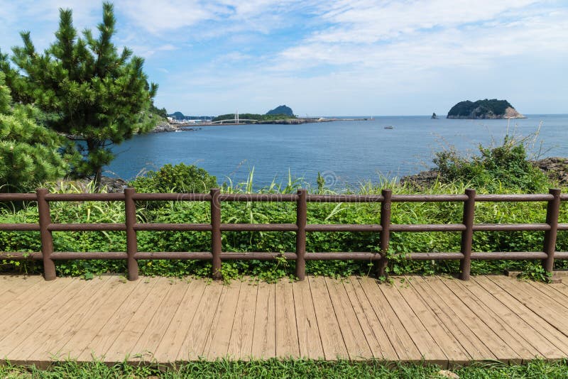 Jeju Olle boardwalk along the ocean with fence in Seogwipo, Jeju Island, Korea