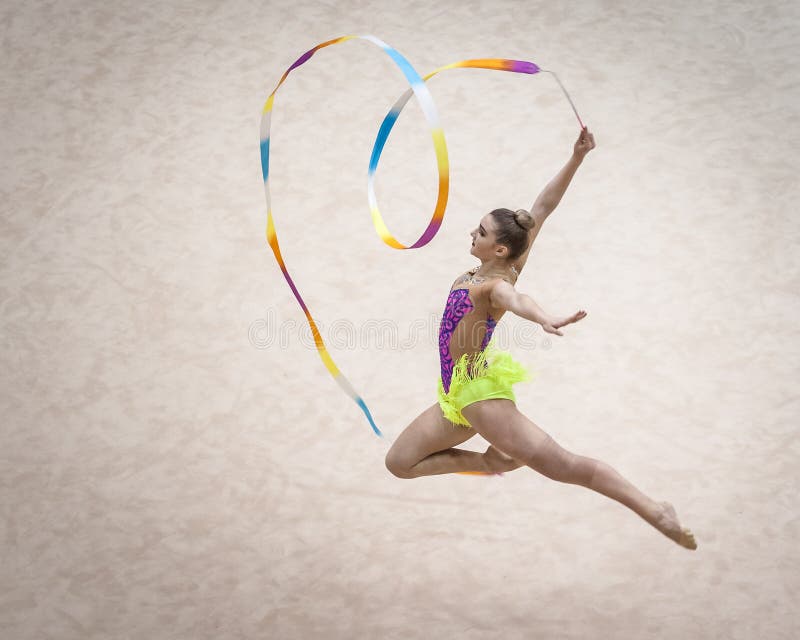 Jelgava, Latvia - April 8, 2018: The Rhythmic Gymnastics Latvian Championship in Jelgava. Jump. Heart ribbon sculpture.