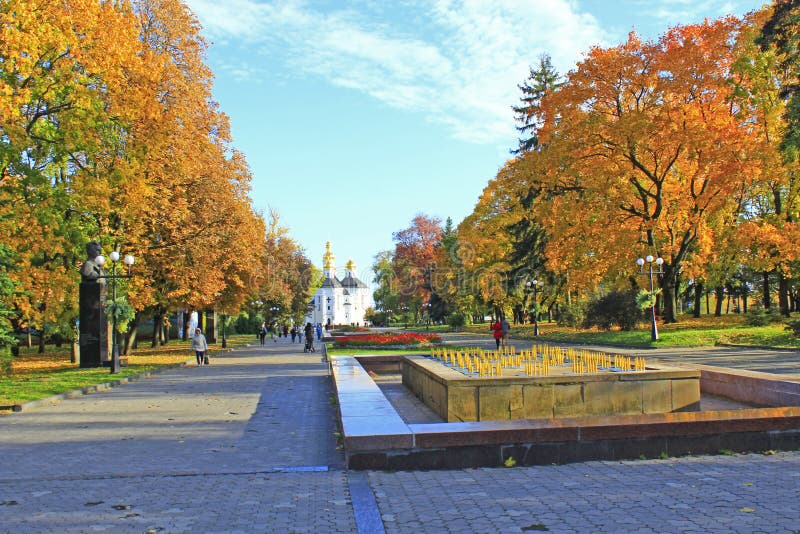 Jesień w miasto parku Żółci drzewa w mieście w spadku Ludzie spaceru w jesień parku zdjęcie royalty free Jesień w miasto parku Żółci drzewa w mieście w spadku Ludzie spaceru w jesień parku zdjęcie royalty free
