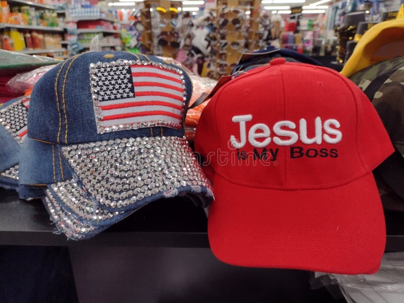 Two hats for sale in a dollar store in Philadelphia, Pennsylvania. One of the hats says, "Jesus is My Boss" while the other, jean hat features a bedazzled American flag. This photo was taken in Philadelphia, Pennsylvania, on December 27th 2023. Two hats for sale in a dollar store in Philadelphia, Pennsylvania. One of the hats says, "Jesus is My Boss" while the other, jean hat features a bedazzled American flag. This photo was taken in Philadelphia, Pennsylvania, on December 27th 2023.