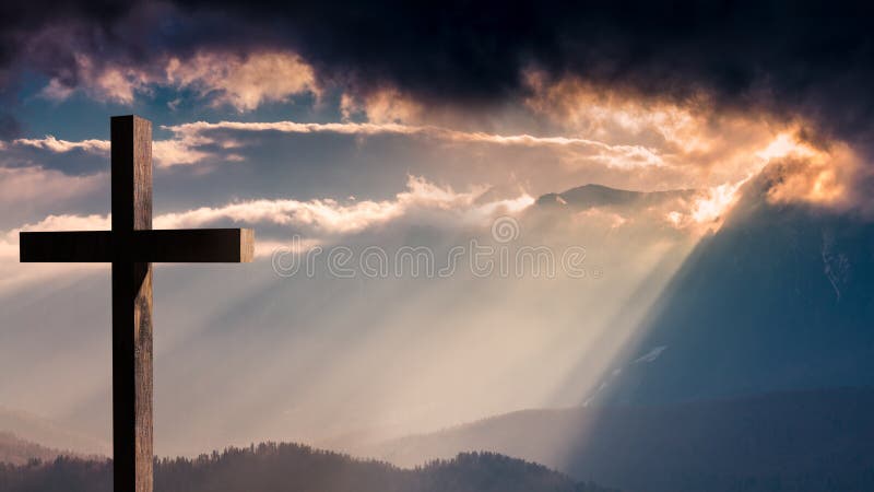 Jesus Christ cross. Easter, resurrection concept. Christian cross on a background with dramatic lighting, colorful mountain sunset, dark clouds and sky and royalty free stock photo