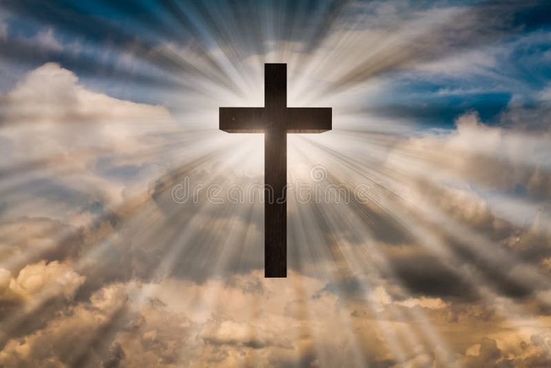 Jesus Christ cross on a sky with dramatic light, clouds, sunbeams. Easter, resurrection, risen Jesus concept. Jesus Christ cross on a blue sky with dramatic stock images